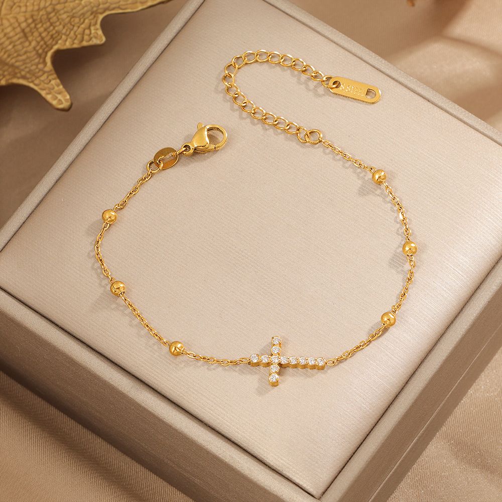 Pulsera de cruz con perlitas doradas